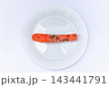 Carrot placed on a white plate with fork and knife at a dining table during meal time 143441791
