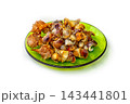Group of Seashells on a Green Plate Arranged for Display on a Table in a Kitchen Setting at Noon 143441801