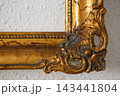 Picture Frame With Ornate Design and Textured Wall Background in a Simple Setting 143441804
