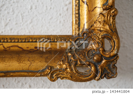 Picture Frame With Ornate Design and Textured Wall Background in a Simple Setting 143441804
