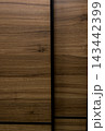 Natural walnut wood texture on sliding wardrobe door close-up. 143442399