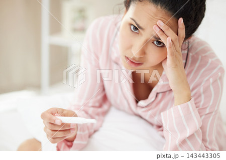 Woman, portrait and stressed in bedroom for pregnancy test with disappointed, sad emotions and frustrated. Female person, panic and nervous for fear of results, tension and worry for infertility 143443305