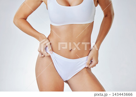 Body, underwear or woman on diet for abdomen, nutrition or natural wellness isolated on white studio background. Weight loss, health or stomach skin of slim model in panties for figure or dermatology Body, underwear or woman on diet for abdomen, nutrition or natural wellness isolated on white studio background. Weight loss, health or stomach skin of slim model in panties for figure or dermatology 143443666