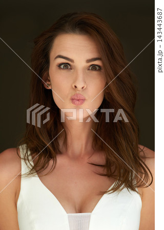 Woman, portrait and face with kiss in studio for romance, flirting and confidence with hair care. Model, girl and pout for skincare satisfaction, beauty treatment and glowing skin on black background 143443687
