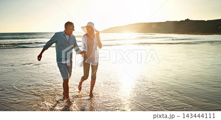 Happy couple, walking and beach for holiday on island or coast for getaway, travel and vacation in Bali. Woman, man and holding hands for love or marriage anniversary by ocean at sunset in Indonesia Happy couple, walking and beach for holiday on island or coast for getaway, travel and vacation in Bali. Woman, man and holding hands for love or marriage anniversary by ocean at sunset in Indonesia 143444111