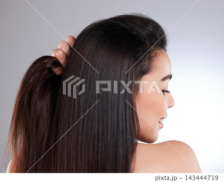 Woman, back and haircare for beauty in studio with keratin treatment, growth and Brazilian for natural shine. Smile, female person and salon for healthy texture of cosmetics on white background 143444719