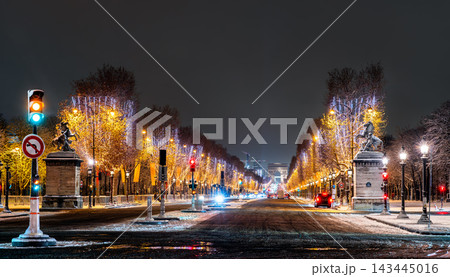Avenue des Champs-Elysees decorated with Christmas lights at night leading toward the Arc de Triomphe in Paris, France. Avenue des Champs-Elysees decorated with Christmas lights at night leading toward the Arc de Triomphe in Paris, France. 143445016