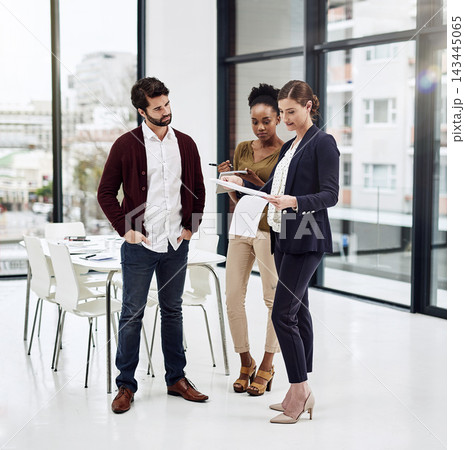 Employee, people and serious at office with tablet for teamwork or collaboration and project. Ideas, discussion and sharing information on internet or online for company growth as graphic designer 143445065