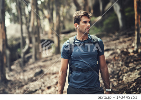 Man, hiking or walking with music in forest for workout, sports and health on mountain. Male person, fitness or exercise with earphones outdoor on adventure for cardio, training or survival journey Man, hiking or walking with music in forest for workout, sports and health on mountain. Male person, fitness or exercise with earphones outdoor on adventure for cardio, training or survival journey 143445253