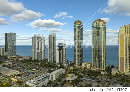 Expensive highrise hotels and condos on Atlantic ocean shore in Sunny Isles Beach city. American tourism infrastructure in southern Florida Expensive highrise hotels and condos on Atlantic ocean shore in Sunny Isles Beach city. American tourism infrastructure in southern Florida 143445507