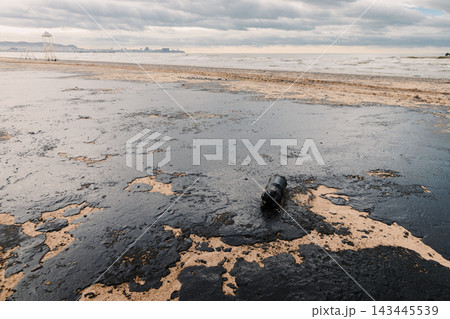 Oil in ocean coastline after a tanker wreck and leakage. Beach is polluted with fuel oil Oil in ocean coastline after a tanker wreck and leakage. Beach is polluted with fuel oil 143445539
