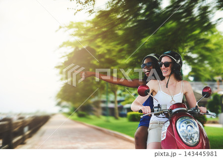 Travel, scooter and women with helmet pointing for adventure, summer vacation or sightseeing. Outdoor, holiday and happy friends with sunglasses for transportation, explore or road trip to India Travel, scooter and women with helmet pointing for adventure, summer vacation or sightseeing. Outdoor, holiday and happy friends with sunglasses for transportation, explore or road trip to India 143445981