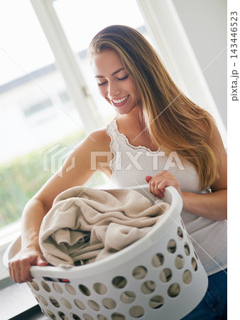 Housework, cleaning and woman with laundry basket, organizing clothes and apparel washing in kitchen. Lady, fabric and housekeeping hygiene with clothing during morning chores routine in lounge Housework, cleaning and woman with laundry basket, organizing clothes and apparel washing in kitchen. Lady, fabric and housekeeping hygiene with clothing during morning chores routine in lounge 143446523
