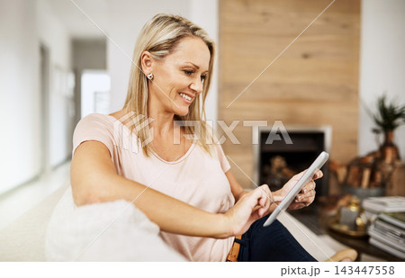 Woman, touch and tablet on sofa for social media, scroll and ebook online on couch. Technology, internet and search on digital website in home, female person an living room for relax and network 143447558