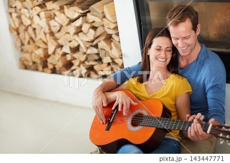 Couple, guitar and smile for music on floor in home with bonding, connection and art in living room. Man, woman and musician with teaching, listen and creativity with instrument on carpet in house Couple, guitar and smile for music on floor in home with bonding, connection and art in living room. Man, woman and musician with teaching, listen and creativity with instrument on carpet in house 143447771
