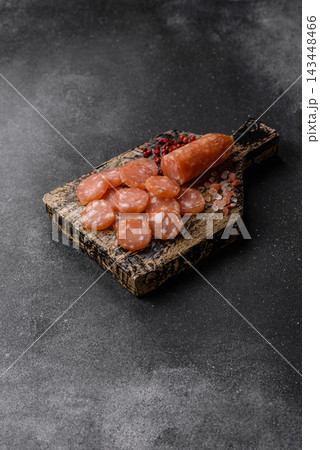Sliced dry cured chicken sausage or smoked meat with salt and spices. Sliced smoked chicken sausage Sliced dry cured chicken sausage or smoked meat with salt and spices. Sliced smoked chicken sausage 143448466