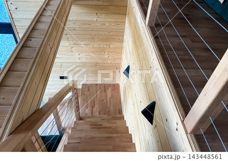 Wooden staircase in modern house with minimalist design and natural light Wooden staircase in modern house with minimalist design and natural light 143448561