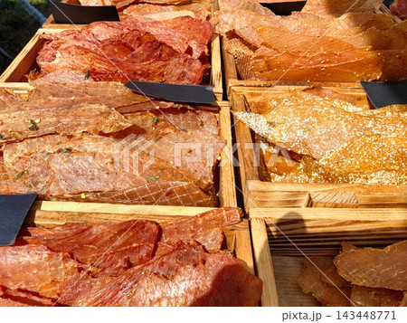 Delicious varieties of jerky on display at a vibrant market 143448771