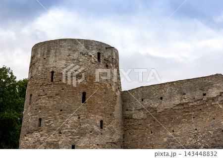 Izborsk Fortress, Pskov Oblast, Russia. Tower is under cloudy sky Izborsk Fortress, Pskov Oblast, Russia. Tower is under cloudy sky 143448832