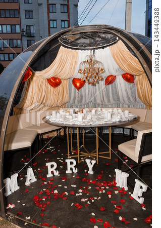 Marry Me Proposal Setup In Vintage Car With Rose Petals Candles Chandelier And Draped Curtains Marry Me Proposal Setup In Vintage Car With Rose Petals Candles Chandelier And Draped Curtains 143449388