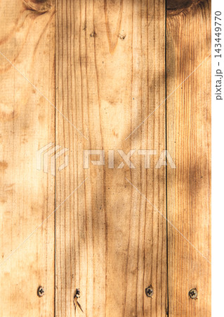 Natural wood texture showcasing warm tones and patterns in sunlight Natural wood texture showcasing warm tones and patterns in sunlight 143449770