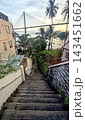 Steep concrete staircase leading down to a coastal view with a large cable-stayed suspension bridge Steep concrete staircase leading down to a coastal view with a large cable-stayed suspension bridge 143451662