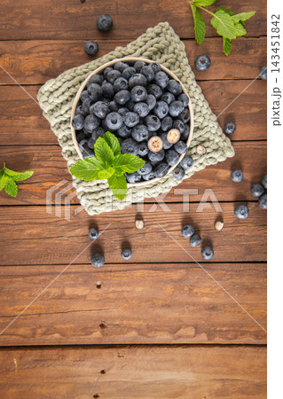Fresh blueberries in bowl on rustic wooden background 143451842