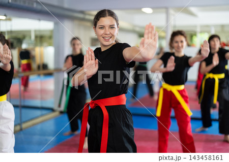 Group of women training karate techniques in studio Group of women training karate techniques in studio 143458161