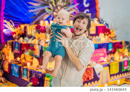 Happy father and baby enjoying a festive Mexican cultural experience. 143460645