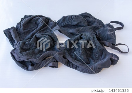 Black lace bras placed together on plain white background. Women lingerie and innerwear apparel product display for fashion retail. Black lace bras placed together on plain white background. Women lingerie and innerwear apparel product display for fashion retail. 143461526