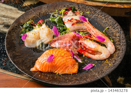 新鮮な魚介を彩りよく盛り付けたおしゃれなカルパッチョ 新鮮な魚介を彩りよく盛り付けたおしゃれなカルパッチョ 143463278