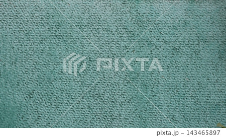 Texture of a green textured wall with decorative plaster. A rough background featuring a fine-grained finish, droplets, and uneven coloring. An excellent grunge base for design, retro-style projects Texture of a green textured wall with decorative plaster. A rough background featuring a fine-grained finish, droplets, and uneven coloring. An excellent grunge base for design, retro-style projects 143465897