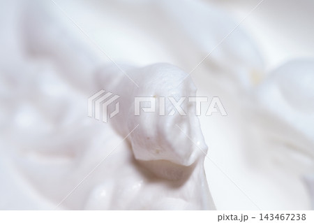 Close-up macro shot of delicious white whipped cream texture with soft peaks 143467238