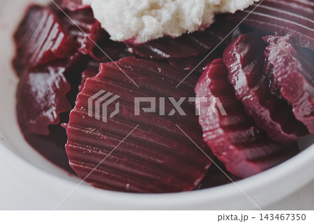 Close-up of delicious sliced beetroot salad garnished with sharp white horseradish Close-up of delicious sliced beetroot salad garnished with sharp white horseradish 143467350