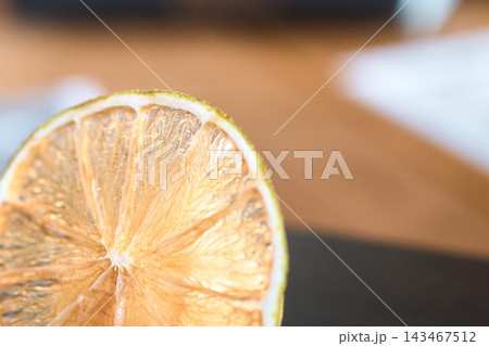 Close-up macro shot of a dried citrus fruit slice showing translucent pulp texture Close-up macro shot of a dried citrus fruit slice showing translucent pulp texture 143467512