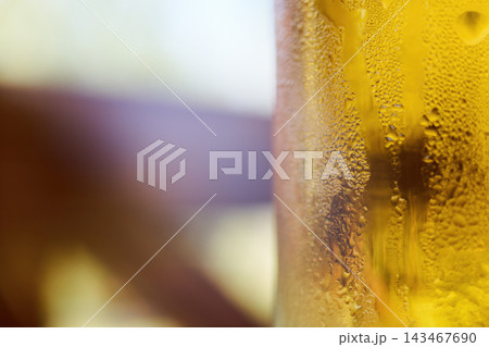 Close-up view of a cold glass of fresh golden beer with water condensation drops Close-up view of a cold glass of fresh golden beer with water condensation drops 143467690