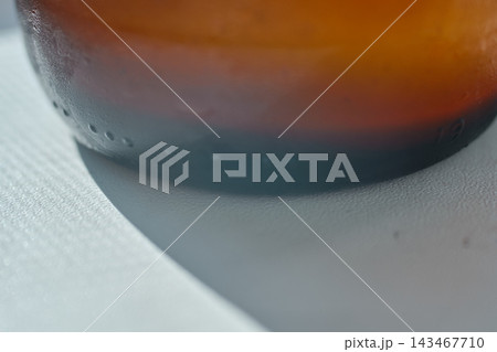 Close-up view of a cold glass bottle filled with refreshing ginger beer beverage 143467710