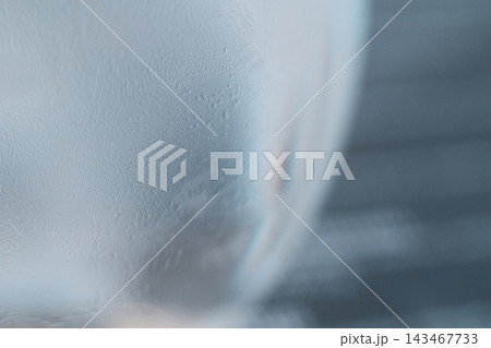 Close-up macro shot of condensation and tiny water droplets on a cold glass surface Close-up macro shot of condensation and tiny water droplets on a cold glass surface 143467733