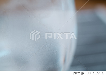Close-up of a cold glass filled with sparkling water and tiny condensation droplets 143467734