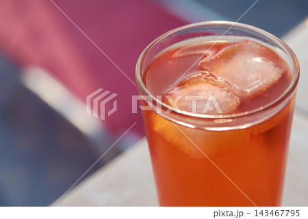 Close-up of a refreshing orange spritz cocktail with ice cubes in a tall glass. Close-up of a refreshing orange spritz cocktail with ice cubes in a tall glass. 143467795