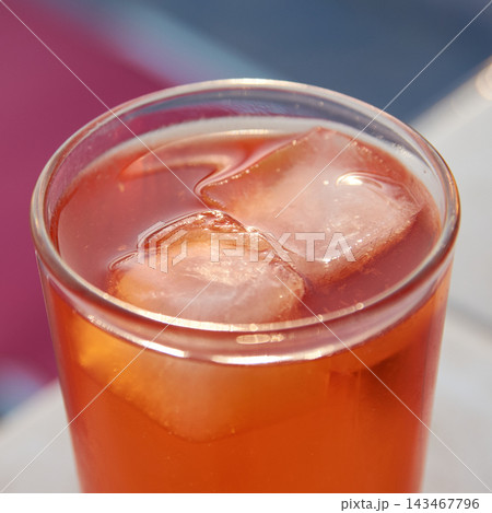 Close-up view of a refreshing orange spritz cocktail with melting ice cubes 143467796