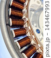 Closeup of copper coils inside electric motor stator 143467993