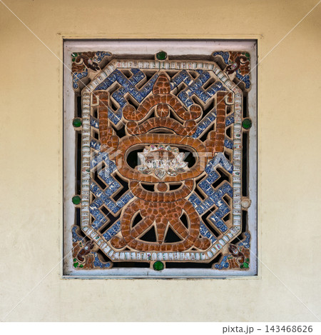 Intricate mosaic window on the external wall of Tam Dai Tu Temple at the Marble Mountains, Da Nang, Vietnam 143468626