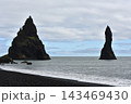 Volcanic Reynisdrangar sea stacks rising near Reynisfjara black sand beach Iceland 143469430