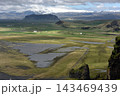 Distant glacier and vast green valley seen from Dyrholaey, Iceland 143469439