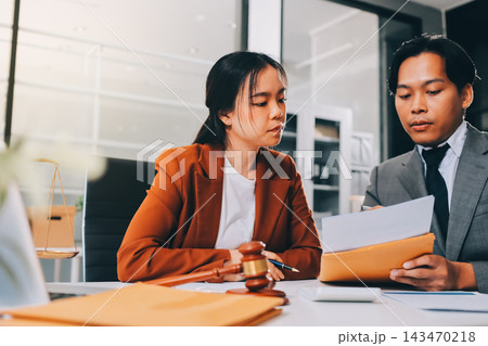 Businessmen or lawyers working together at a meeting, teamwork and partnership. Signing documents, contracts, checking details business agreement 143470218