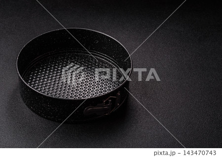 Black aluminum round baking mold for making pies at home. Round baking mold Black aluminum round baking mold for making pies at home. Round baking mold 143470743
