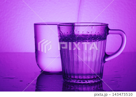 Pure water fluoride free pours into glass, concept wellness detox healthy drinks 143473510