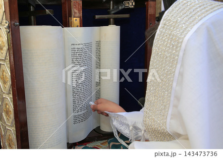 Jewish boy reading from open Torah scroll during Bar Mitzvah ceremony at Western Wall, Jerusalem, Israel Jewish boy reading from open Torah scroll during Bar Mitzvah ceremony at Western Wall, Jerusalem, Israel 143473736