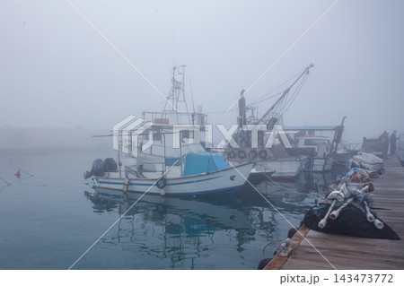 Fishing boats in the foggy harbor of Jaffa port. Israel 143473772